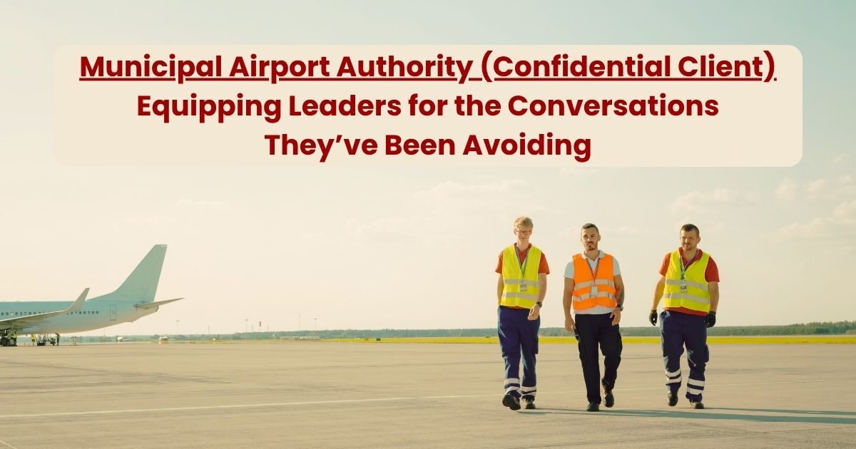 Three airport operations workers in high-visibility safety vests walk together across an airport tarmac with a parked aircraft in the background.