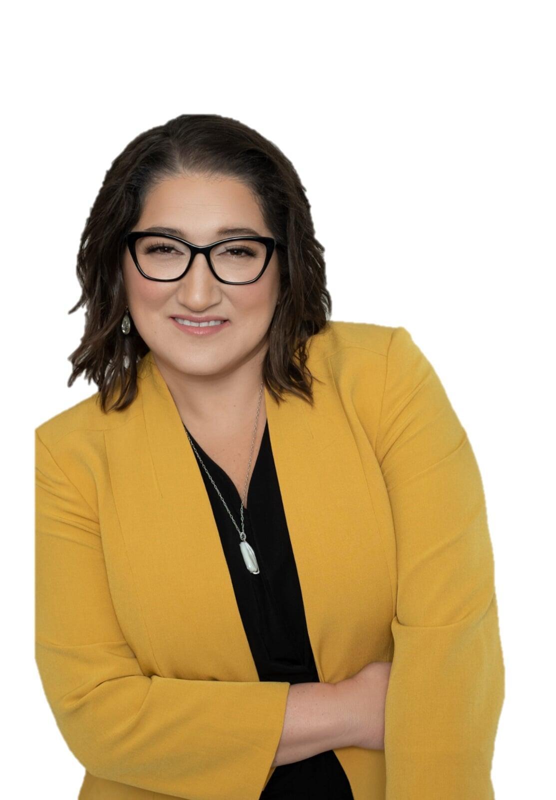 Amy C. Waninger wearin a black blouse and gold blazer blouse